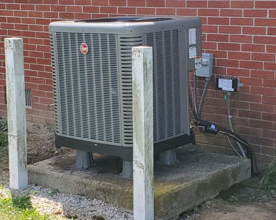 Residential HVAC condenser unit installed on a concrete pad by Precise Comfort HVAC