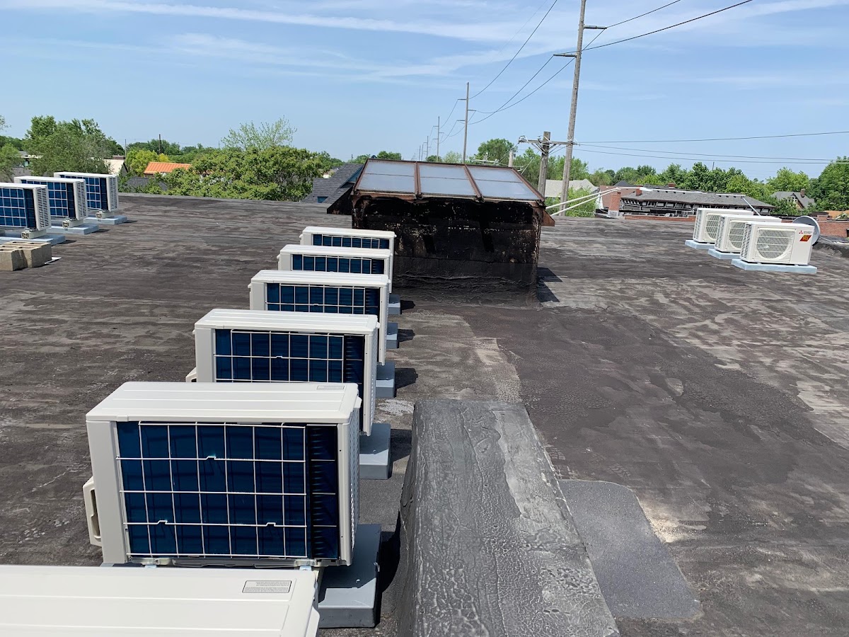 Row of commercial rooftop HVAC condenser units installed by Precise Comfort HVAC